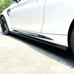 BMW M2 F87 OEM Style Carbon Fibre Side Skirt Extensions — front three-quarter view